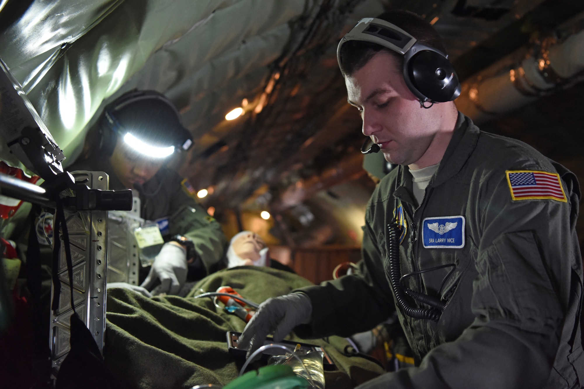 U.S. Air Force Staff Sgt. Yannick Sharras (left), 86th Aeromedical Evacuation Squadron medical technician, Ramstein Air Base, Germany, and Senior Airman Larry Nice, 86th AES medical technician, prepare a patient for medical evacuation aboard a KC-135 Stratotanker, Jan. 23, 2019. During the training, members underwent emergency medical scenarios, including treatment for patients suffering worsening health conditions, cardiac emergencies, aircraft decompression, and emergency ditching. (U.S. Air Force photo by Airman 1st Class Brandon Esau)