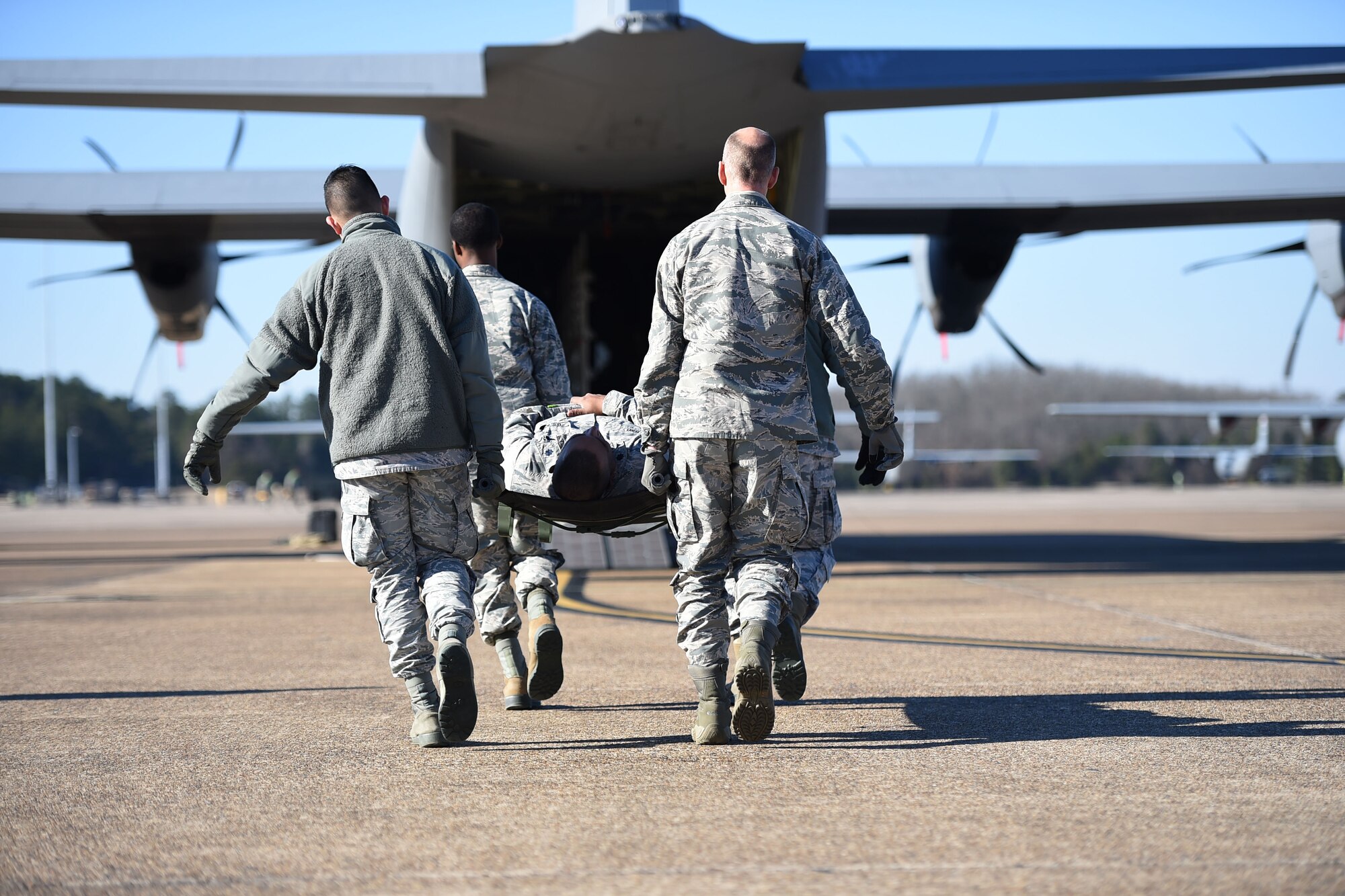 Airmen from the 19th Medical Group litter-carry a simulated patient onto a C-130J during an aeromedical evacuation training mission at Little Rock Air Force Base, Ark., Jan. 24, 2019. The training provided 19th MDG Airmen with hands-on training of airlift and aeromedical evacuation tactics, supporting rapid global mobility to respond to humanitarian or wartime requests to safeguard lives. (U.S. Air Force photo by Staff Sgt. Dana J. Cable)