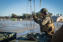 U.S. Marine Corps Staff Sgt. Shane Armstrong, an artillery cannon operator with 5th Battalion, 11th Marine Regiment, 1st Marine Division, secures a stack of M270 rockets to an M142 high-mobility artillery rocket system during exercise Steel Knight (SK) 19 at Marine Corps Base Camp Pendleton, California, Dec. 7, 2018.