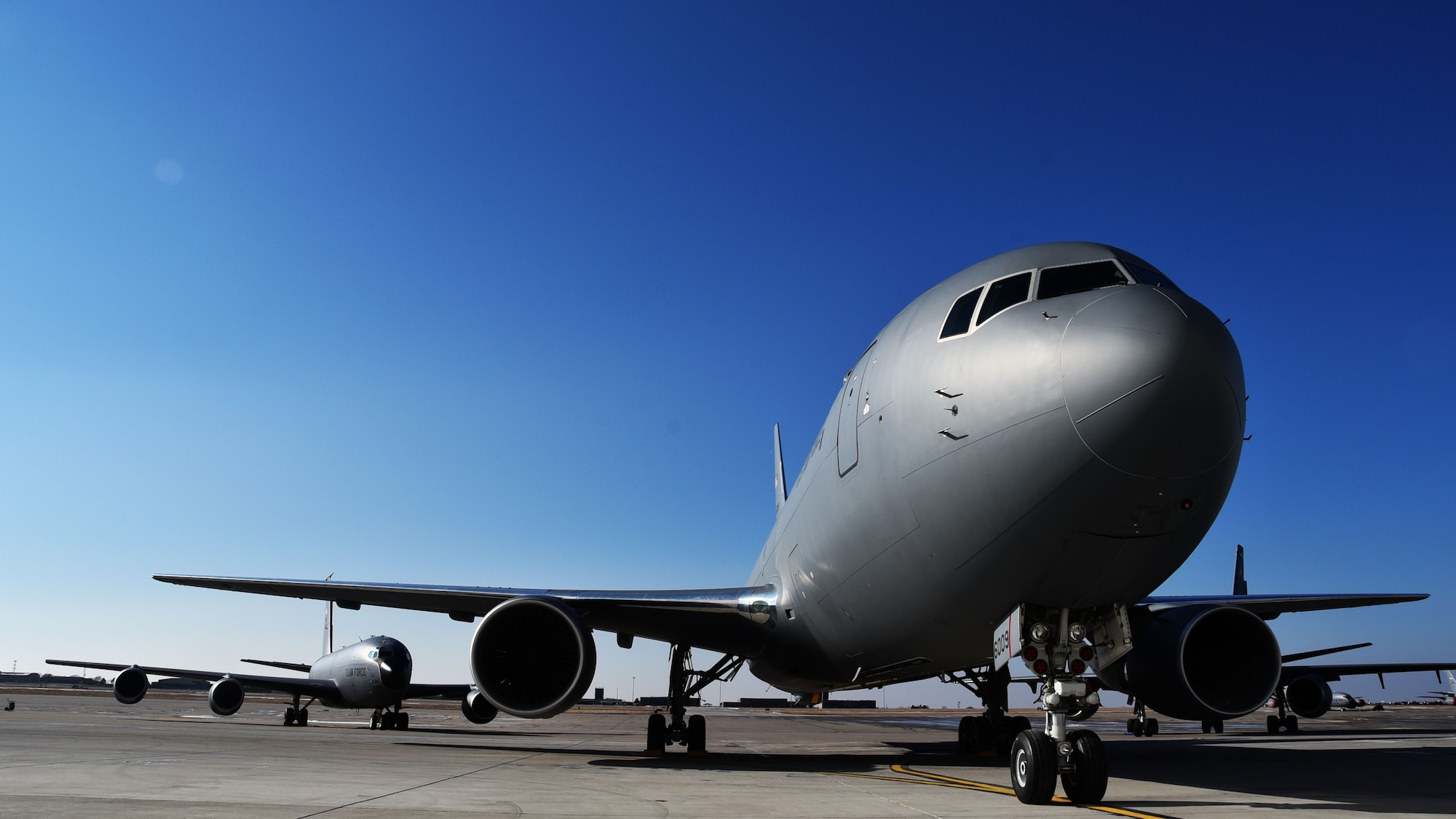 The first KC-46A Pegasus delivered to Team McConnell, sits on the flightline with a KC-135 Stratotanker close behind it, Jan. 25, 2019, McConnell Air Force Base, Kan. McConnell received two KC-46As, the next generation in air refueling aircraft.
