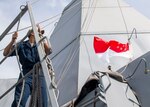 SINGAPORE (Jan. 26, 2019) Quartermaster Seaman Cesar Vallejauregui, from San Diego, raises the Singapore national flag aboard the San Antonio-class amphibious transport dock ship USS Anchorage (LPD 23) during a port visit to Singapore while on a deployment of the Essex Amphibious Ready Group (ARG) and 13th Marine Expeditionary Unit (MEU). The Essex ARG/ 13th MEU is a capable and lethal Navy-Marine Corps team deployed to the 7th fleet area of operations to support regional stability, reassure partners and allies and maintain a presence postured to respond to any crisis ranging from humanitarian assistance to contingency operations.