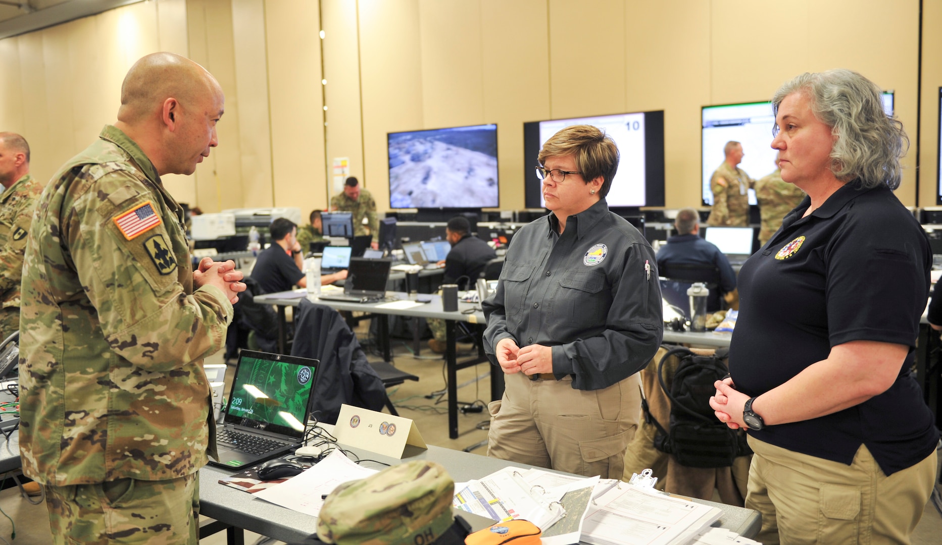 U.S. Army Col. Eric Oh (left), Joint Task Force Civil Support (JTF-CS) director of operations, speaks with Erin Sutton (middle), City of Virginia Beach emergency manager, and Carolyn Holmes (right), JTF-CS interagency planner, during Exercise Sudden Response 19 in Fayetteville, N.C., Jan. 26. The weeklong exercise is a critical training component for JTF-CS and its training partners. The unit is a standing joint task force tasked to respond to a catastrophic chemical, biological, radiological, or nuclear (CBRN) event in the U.S. (Official DoD photo by Staff Sgt. Jeramy Moore/released)