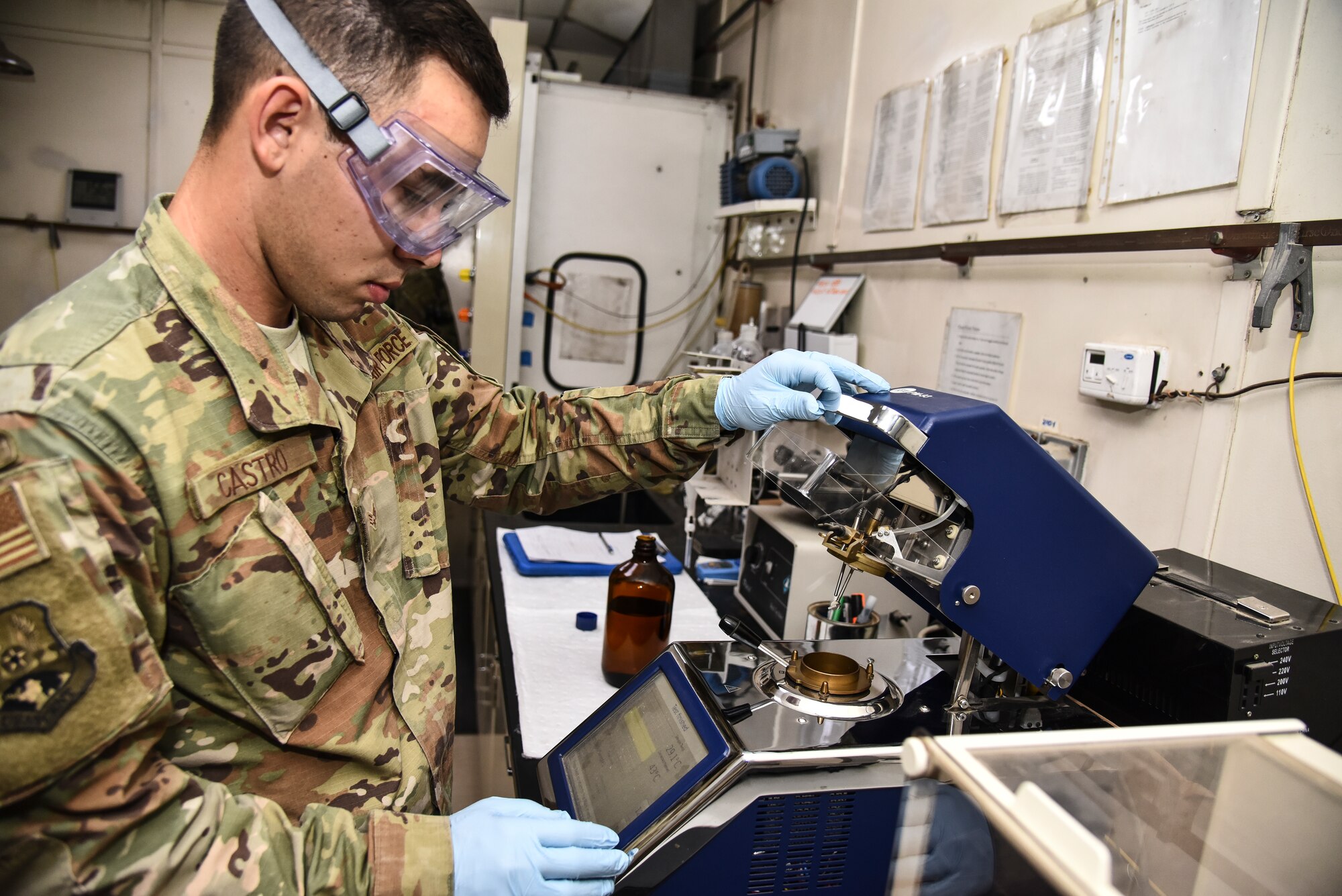 U.S. Air Force Senior Airman Anthony Castro, 380th Expeditionary Logistics Readiness Squadron fuels laboratory technician, operates an Automated Flash Tester at Al Dhafra Air Base, United Arab Emirates, Jan. 21, 2019. The lab personnel sample all fuel grades from the fuel bladders, tanks, trucks and pipeline receipt on a daily basis. (U.S. Air Force photo by Senior Airman Mya M. Crosby)