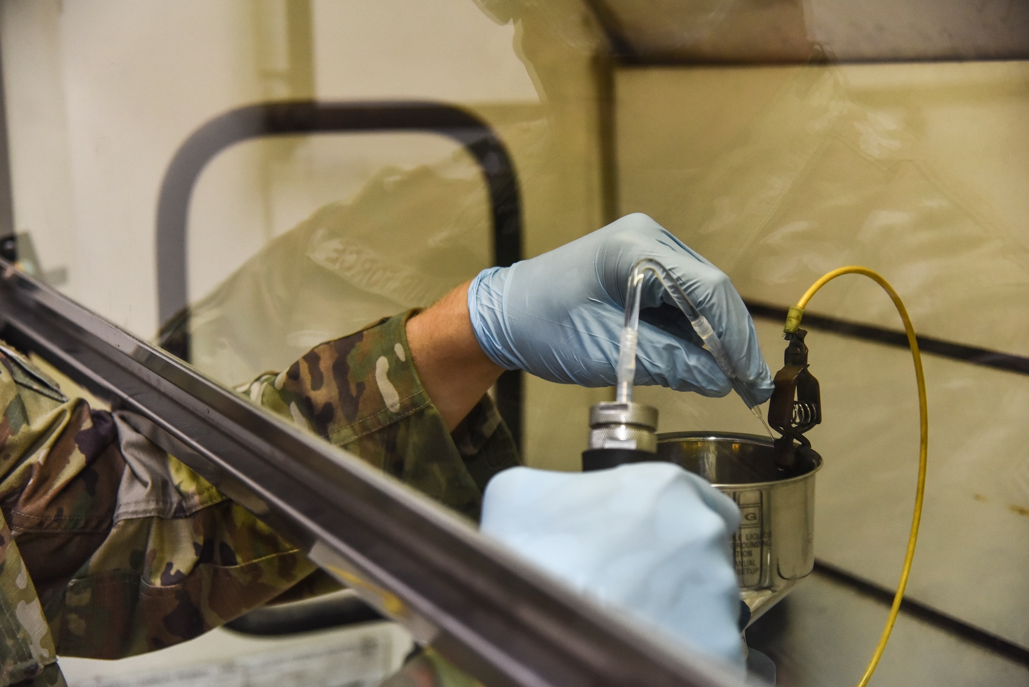 U.S. Air Force Staff Sgt. Ronald Wilkey, 380th Expeditionary Logistics Readiness Squadron fuels laboratory supervisor, performs a bottle method test to determine the particle content of the fuel at Al Dhafra Air Base, United Arab Emirates, Jan. 21, 2019. The lab personnel sample all fuel grades from the fuel bladders, tanks, trucks and pipeline on a daily basis. (U.S. Air Force photo by Senior Airman Mya M. Crosby)
