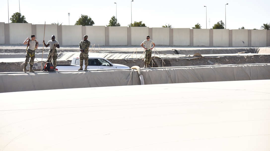 U.S. Airmen assigned to the 380th Expeditionary Logistics Readiness Squadron fuels flight, prepare to measure a fuel bladder at Al Dhafra Air Base, United Arab Emirates, Jan. 21, 2019. The fuel bladders have approximately the same thickness of a water bed liner, which is strong enough to hold 210,000 gallons of fuel. (U.S. Air Force photo by Senior Airman Mya M. Crosby)