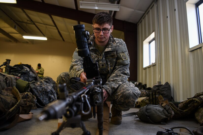Spc. Brandon Jackson, 2-325th Airborne Infantry Regiment machine gunner, cleans his weapon before his platoon begins the second level of cold-weather gunnery qualification training on Joint Base McGuire-Dix-Lakehurst, New Jersey, Jan. 15, 2019. The Soldiers were required to qualify each level of gunnery training in freezing conditions to stay in the regiment. (U.S. Air Force photo by Airman 1st Class Ariel Owings)