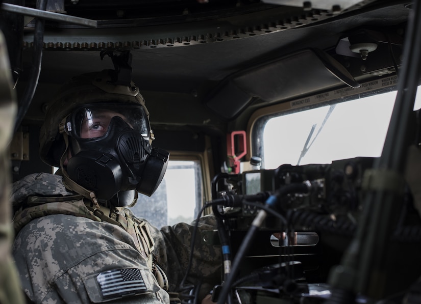 A Soldier assigned to the 2-325th Airborne Infantry Regiment looks up at the machine gunner during the cold-weather gunnery qualification training on Joint Base McGuire-Dix-Lakehurst, New Jersey, Jan. 17, 2019. The Soldiers inside the HUMVEE were responsible for making sure the machine gunner was attached to the safety line and ready before they could drive. (U.S. Air Force photo by Airman 1st Class Ariel Owings)