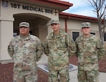 (From left) Staff Sgt. Jose Dominguez, Spc. Alexsi Valle and Spc. Calvin Duke stand in front of the 1st Medical Brigade Head Quarters Jan. 10, 2019 at Fort Hood, Texas.