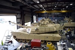 M1 Abrams tanks and other tracked vehicles sit in the maintenance bay at the South Carolina National Guard Unit Training Equipment Site on McCrady Training Center in Eastover, South Carolina, Jan. 23, 2019. Vehicle maintenance and repairs in the National Guard often falls to dual-status technicians - federal civilian employees who are required to maintain membership in a Guard unit as part of their employment. Technicians are also required to wear their military uniform and adhere to military customs and courtesies while on duty.  This month marks the 50-year anniversary of the technician program, which came into being Jan. 1, 1969.