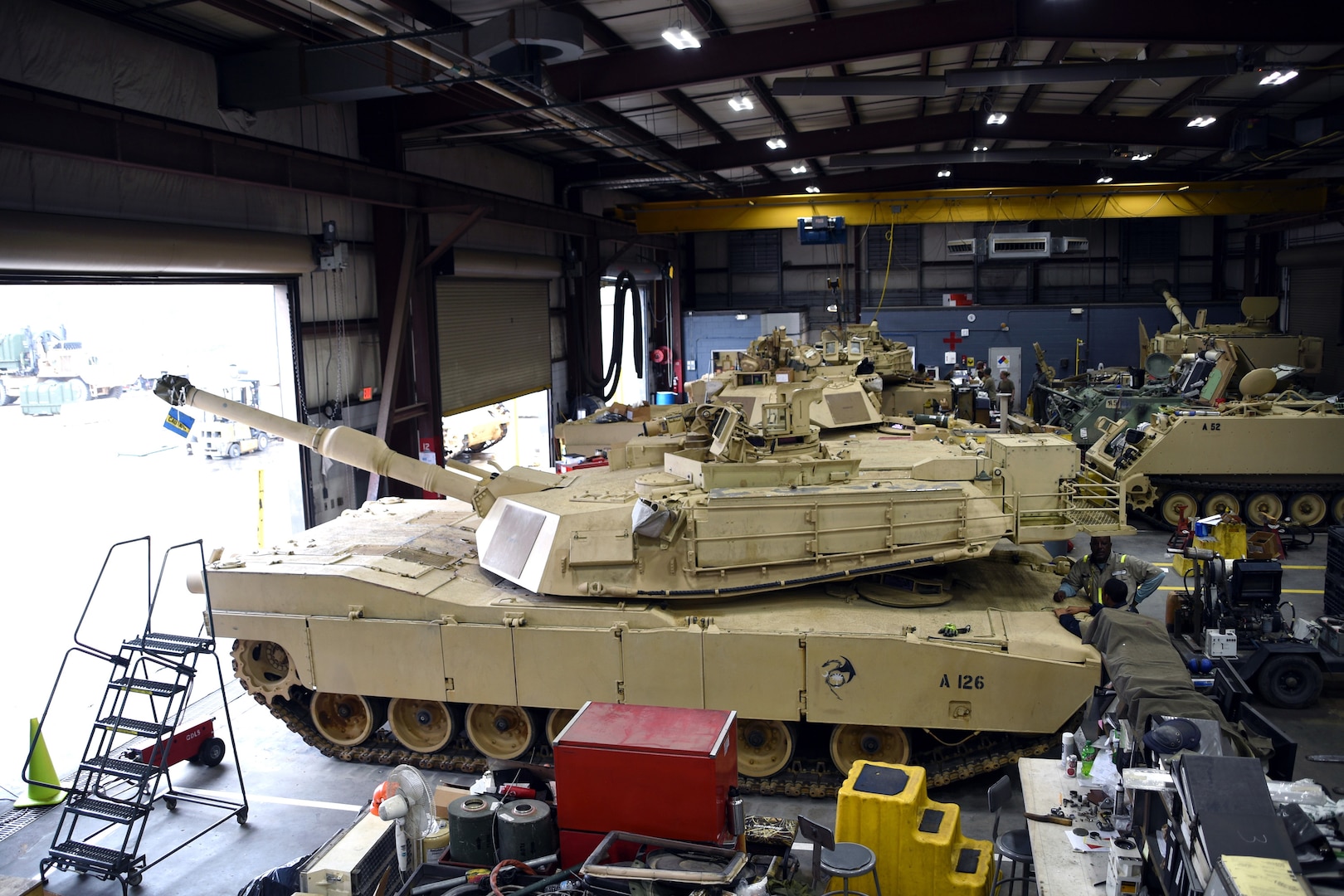 M1 Abrams tanks and other tracked vehicles sit in the maintenance bay at the South Carolina National Guard Unit Training Equipment Site on McCrady Training Center in Eastover, South Carolina, Jan. 23, 2019. Vehicle maintenance and repairs in the National Guard often falls to dual-status technicians - federal civilian employees who are required to maintain membership in a Guard unit as part of their employment. Technicians are also required to wear their military uniform and adhere to military customs and courtesies while on duty.  This month marks the 50-year anniversary of the technician program, which came into being Jan. 1, 1969.