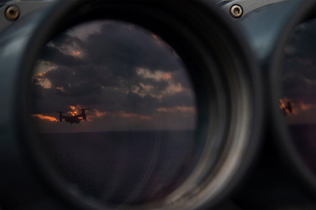 A Marine Corps aircraft prepares to land on a ship.