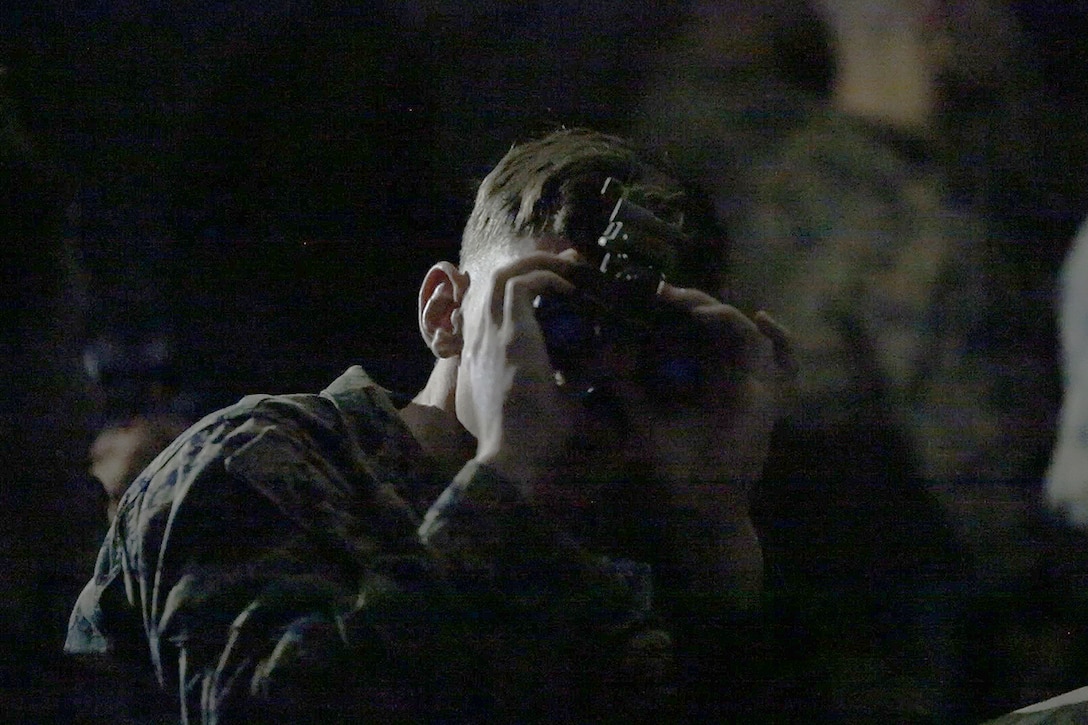 A Marine peers through the lens of the Squad Binocular Night Vision Goggles during new equipment training in December 2018 at Camp Lejeune, North Carolina. The move to the SNBVG is expected to enhance the infantry’s lethality and situational awareness in reduced visibility