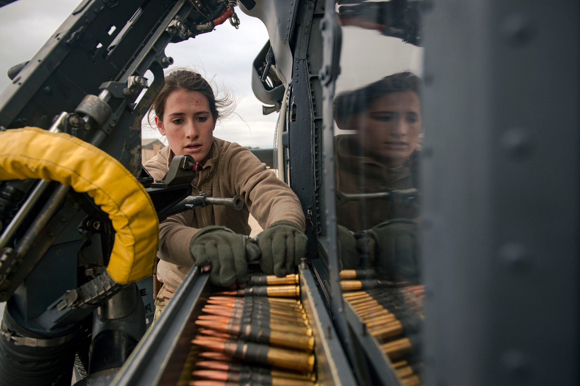 Airman 1st Class Lauren Cox, 41st Rescue Squadron (RQS) special missions aviator, loads ammunition into an M2 machine gun mount on an HH-60G Pave Hawk helicopter during routine training, Jan. 16, 2019, at Moody Air Force Base, Ga. To optimally perform their Combat Search and Rescue mission downrange, the 347th Rescue Group implemented the advanced training ‘hard crew’ system, which unifies the 38th and 41st RQS’s into separate rescue operator teams that’ll fly every mission together for their upcoming deployment. This concept establishes continuity and chemistry which will help maximize the 38th and 41st RQS’s mission readiness by simultaneously working together to build relationships and understand each other’s idiosyncrasies, strengths, and weaknesses to ultimately improve the team’s performance in mission execution. (U.S. Air Force photo by Senior Airman Greg Nash)