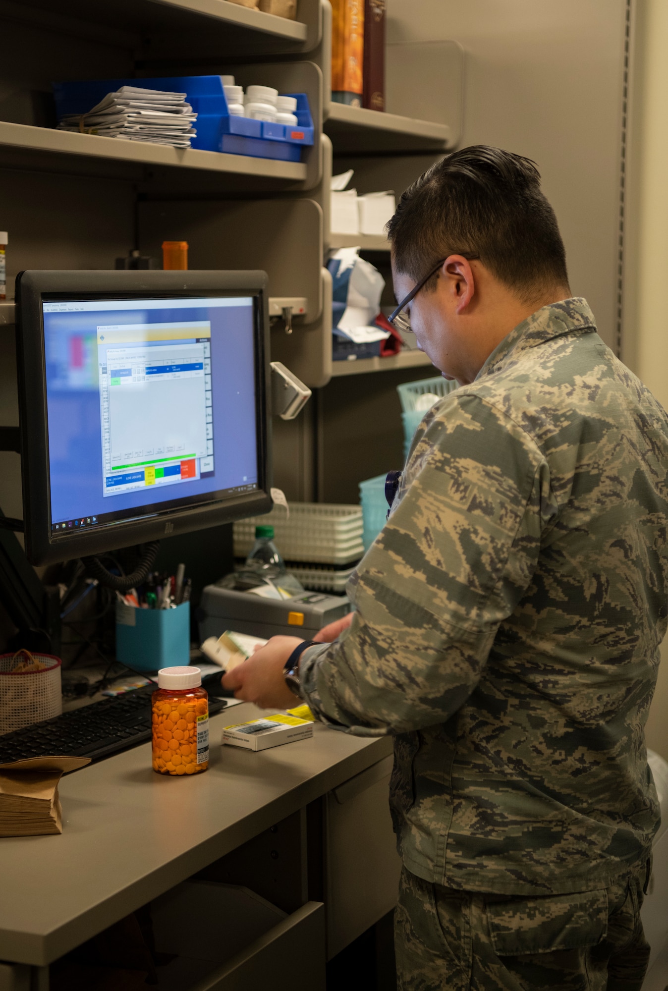 Maj. Jin Kim, 436th Medical Group pharmacy flight commander, verifies medication before giving prescriptions to patients Jan. 22, 2019, at Dover Air Force Base, Delaware. Team Dover’s pharmacy is unique in that it is primarily staffed by volunteers. (U.S. Air Force photo by Airman 1st Class Zoe M. Wockenfuss)