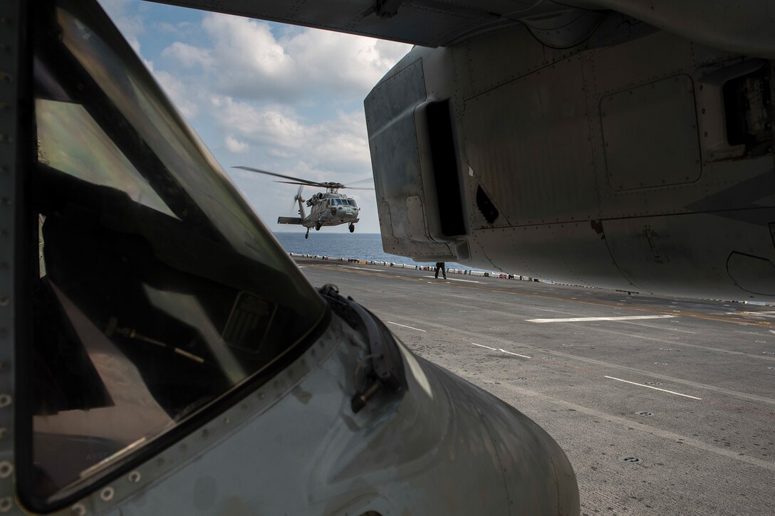 A helicopter takes off a ship.