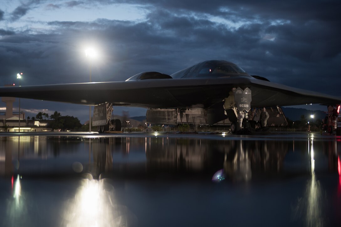 Service members prep an Air Force B-2 Spirit bomber for a training mission.