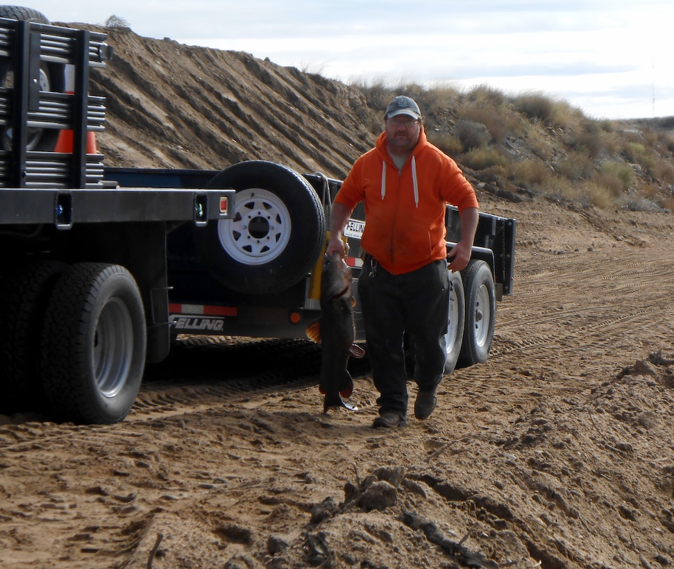 JOHN MARTIN RESERVOIR, Colo. – A CPW volunteers holds up one of the fish salvaged from the stilling basin, Nov. 1, 2018.