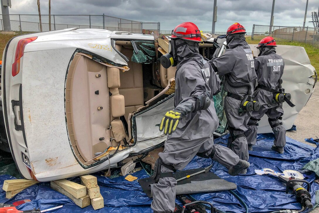 Soldiers attempt to enter a simulated crashed vehicle.