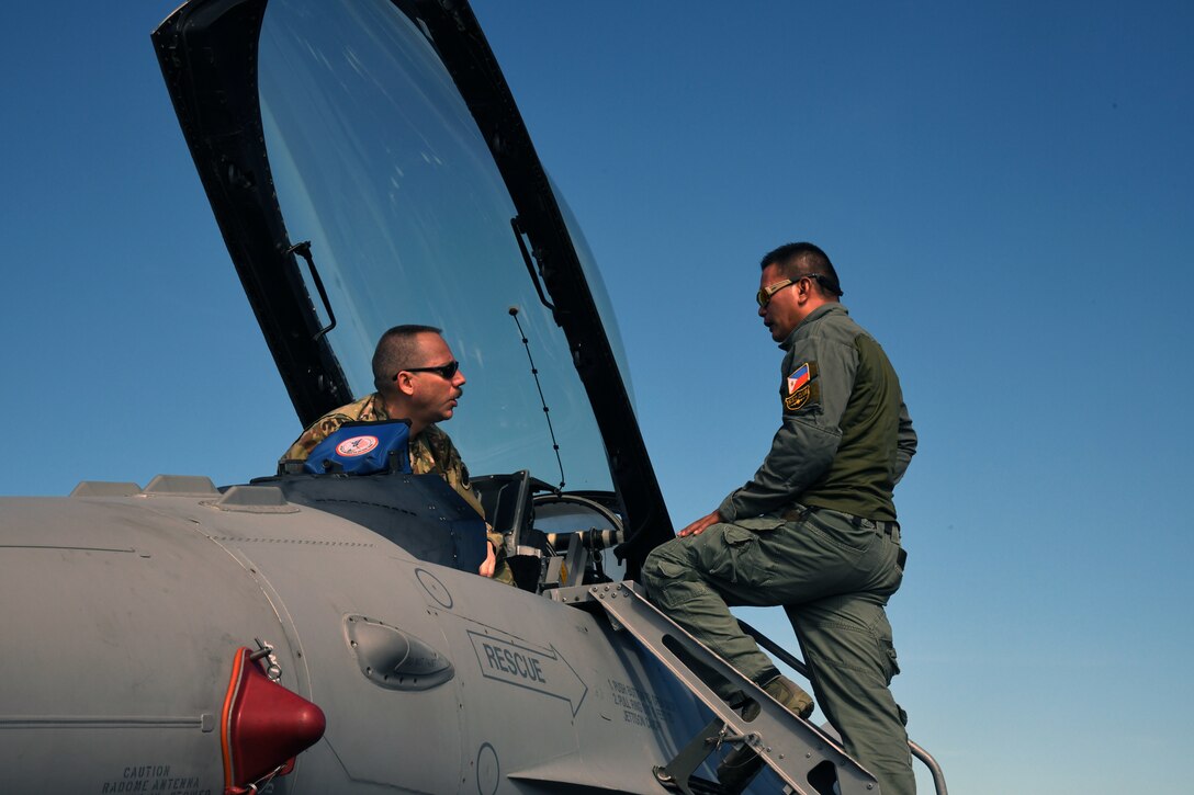 U.S. Air Force Tech Sgt. Ed Edens, 113th Maintenance Squadron Egress system mechanic, left, and Philippine Air Force Tech. Sgt. Roderick Domingo, 430th Aircraft Maintenance Group Egress system supervisor, right, perform a visual inspection of a U.S. Air Force F-16 Fighting Falcon during the Bilateral Air Contingent Exchange-Philippines (BACE-P) at Cesar Basa Air Base, Philippines, Jan. 22, 2019.