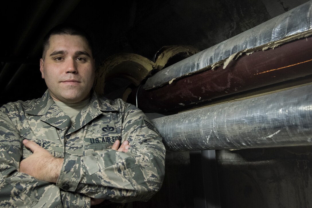 Staff Sgt. Layton Little, 374 Civil Engineer Squadron service contract manager, poses for a photo under the pool at Yokota Air Base, Japan, Jan. 23, 2019. Little is the foreman for the team working to fix damaged equipment under the pool. (U.S. Air Force photo by Machiko Arita)