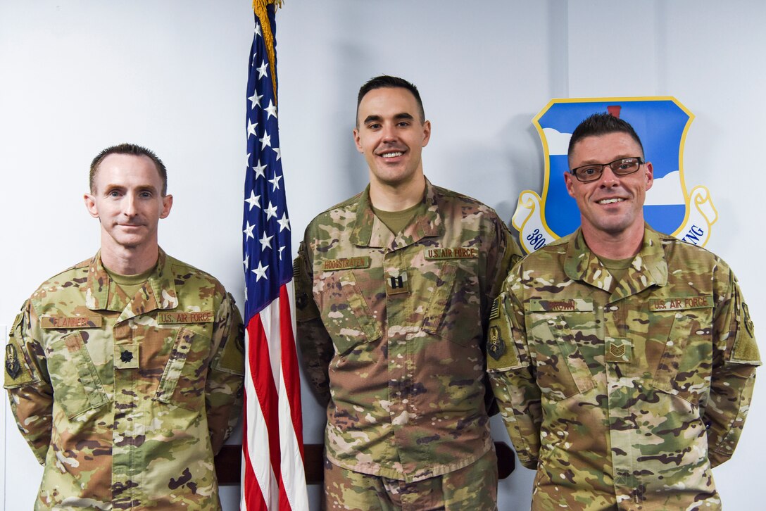 The 380th Air Expeditionary Wing legal team Lt Col. Jeremy Flannery, Staff Judge Advocate, Capt. Ross Hoogstraten, Deputy Staff Judge Advocate, and Tech. Sgt. Rich Brown, 380th AEW NCOIC of legal office, pose for a group photo, Jan. 24, 2019 at Al Dhafra Air Base, United Arab Emirates.