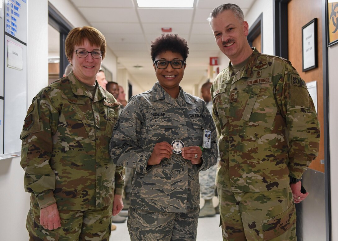 U.S. Air Force Lt. Gen. Dorothy A. Hogg, Air Force Surgeon General, and Chief Master Sgt. G. Steve Cum, Medical Enlisted Force and Enlisted Corps chief, present a coin to Master Sgt. Teronda L. Hunter, 633rd Dental Squadron clinical flight chief, at Joint Base Langley-Eustis, Virginia, Jan. 9, 2019.