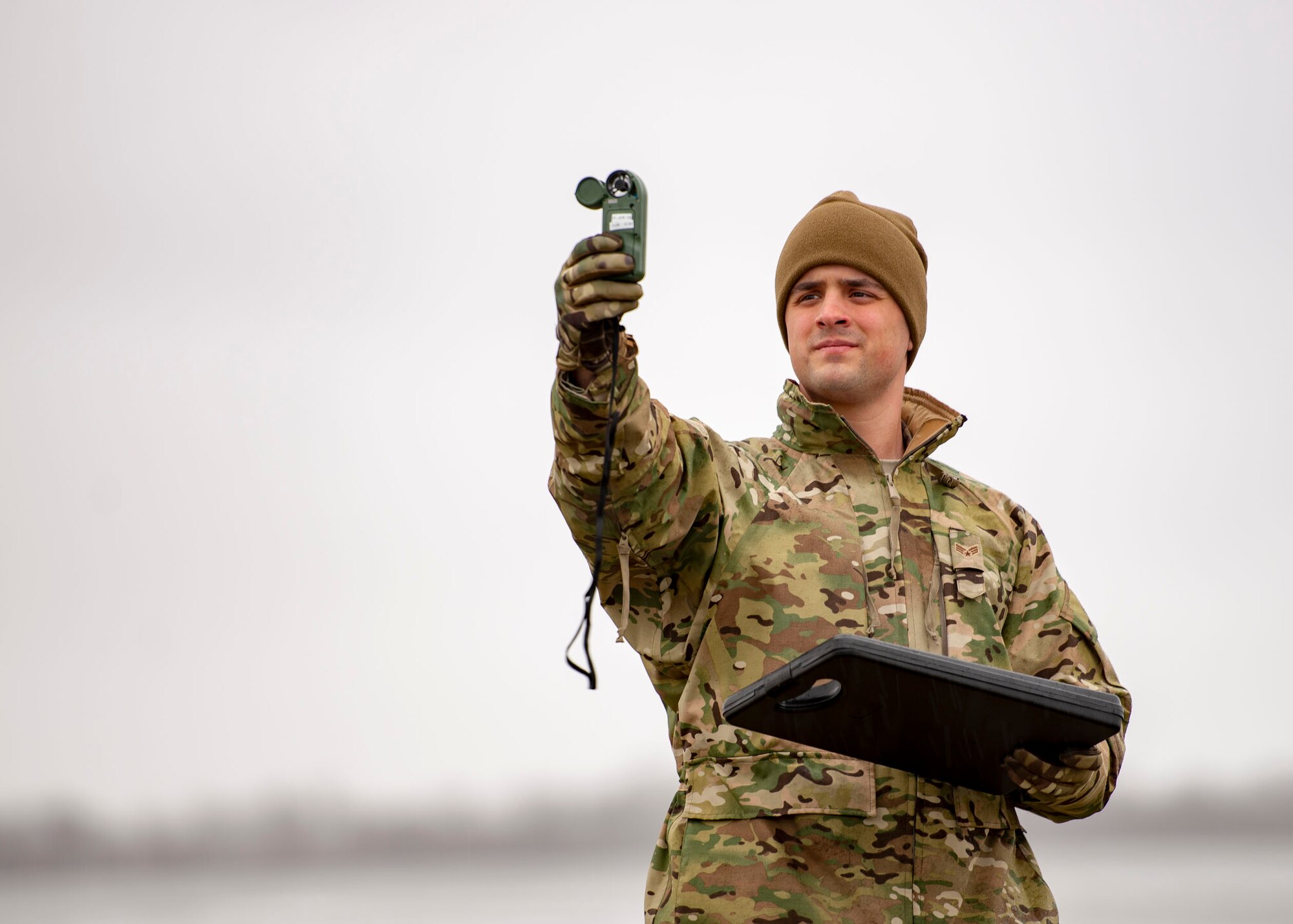 Senior Airman Aaron Cathey, 436th Operations Support Squadron weather forecaster, uses a handheld weather-monitoring device to gather meteorological information Jan. 24, 2019, on Dover Air Force Base, Delaware. Checks using the handheld device are taken from the same location to ensure consistency. (U.S. Air Force photo by Staff Sgt. Jared Duhon)