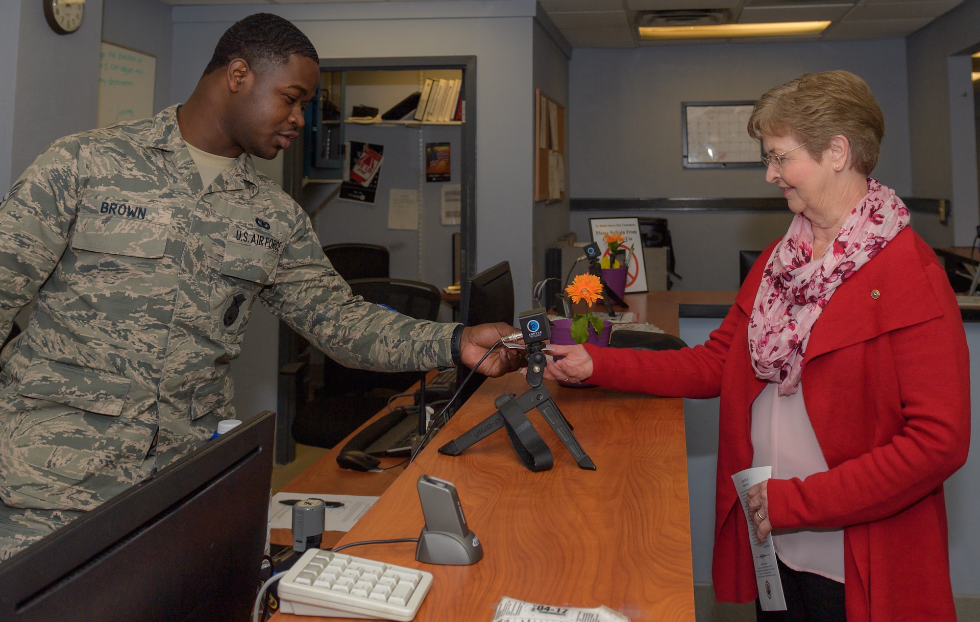 U.S. Air Force Senior Airman Leonard Brown, 81st Security Forces visitors center clerk, provides a Gold Star Family Member ID card to Ann Hamilton, sister of Staff Sgt. James W. Davis, inside the visitor center at Keesler Air Force Base, Mississippi, Jan. 24, 2019. Davis was killed in 1968 while conducting military operations in Vietnam . (U.S. Air Force photo by Andre' Askew)