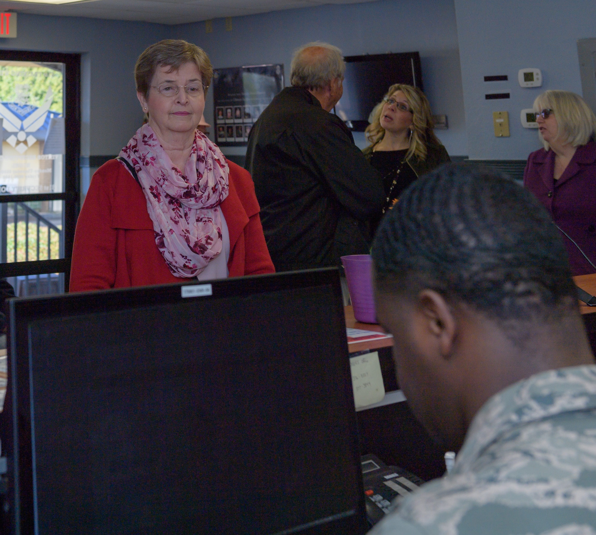 U.S. Air Force Senior Airman Leonard Brown, 81st Security Forces Squadron visitors center clerk, provides a Gold Star Family Member ID card to Ann Hamilton, sister of Staff Sgt. James W. Davis at the visitor center at Keesler Air Force Base, Mississippi, Jan. 24, 2019.  Davis was killed in 1968 while conducting military operations in Vietnam. (U.S. Air Force photo by Andre' Askew)