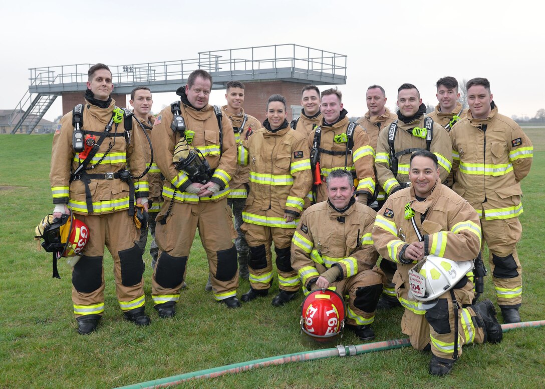 U.S. Air Force Chief Master Sgt. Kristina Rogers, 100th Air Refueling Wing command chief, center, poses with firefighters from the 100th Civil Engineer Squadron after she participated in structural live-fire training at RAF Mildenhall, England, Jan. 24, 2019. The 100th ARW command chief participated in the training, performed semi-annually, to get an idea of what the RAF Mildenhall firefighters go through to keep up-to-date in their fundamental skills. (U.S. Air Force photo by Karen Abeyasekere)