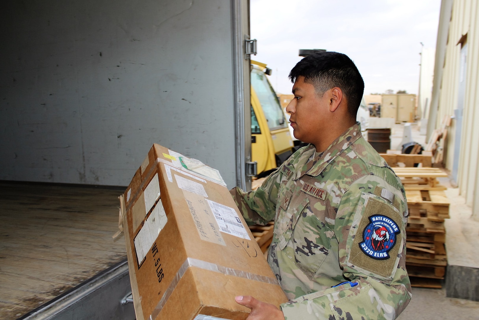 :  SOUTHWEST ASIA – Senior Airman Andrew Fabian, 332nd Air Expeditionary Wing, 332nd Expeditionary Logistics Readiness Squadron vehicle operator, loads packages onto a delivery truck at an undisclosed location, January 19.  The 332 ELRS ground transportation team performs several delivery “sweeps” each day, picking up and delivering personnel and cargo to and from all the main warehouses, supply shops and aircraft. (US Air Force photo by Maj. John T. Stamm)