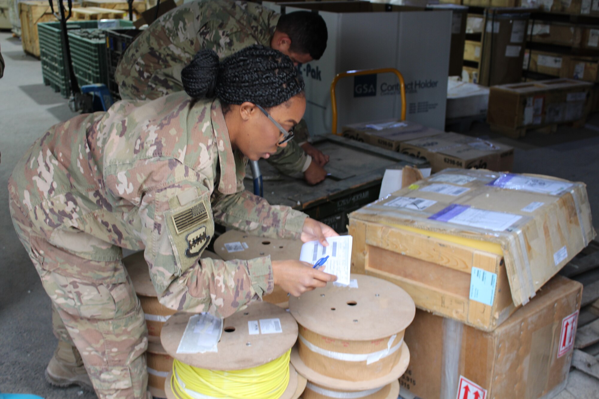 SOUTHWEST ASIA – Senior Airman Cheyenne Smith, 332nd Air Expeditionary Wing, 332nd Expeditionary Logistics Readiness Squadron customer service representative, checks the invoice numbers on an outgoing shipment at an undisclosed location, January 19.  At its busiest, the 332 ELRS moves over 4,500 personnel and 5,000 short tons (10 million lbs.) of cargo every 3-months. (US Air Force photo by Maj. John T. Stamm)
