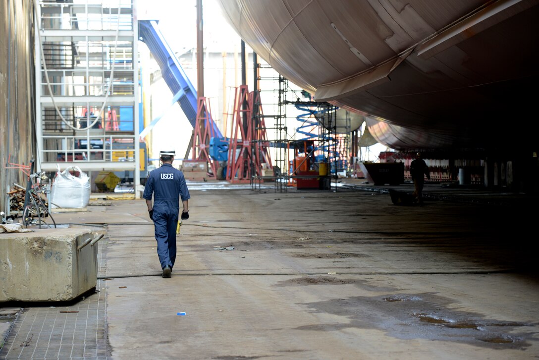 Lt. j.g. Ryan Thomas, a marine Inspector at Coast Guard Sector Delaware Bay, walks below the Kaimana Hila, an 850-foot container ship being constructed in Philadelphia Shipyards, Oct. 4, 2018.