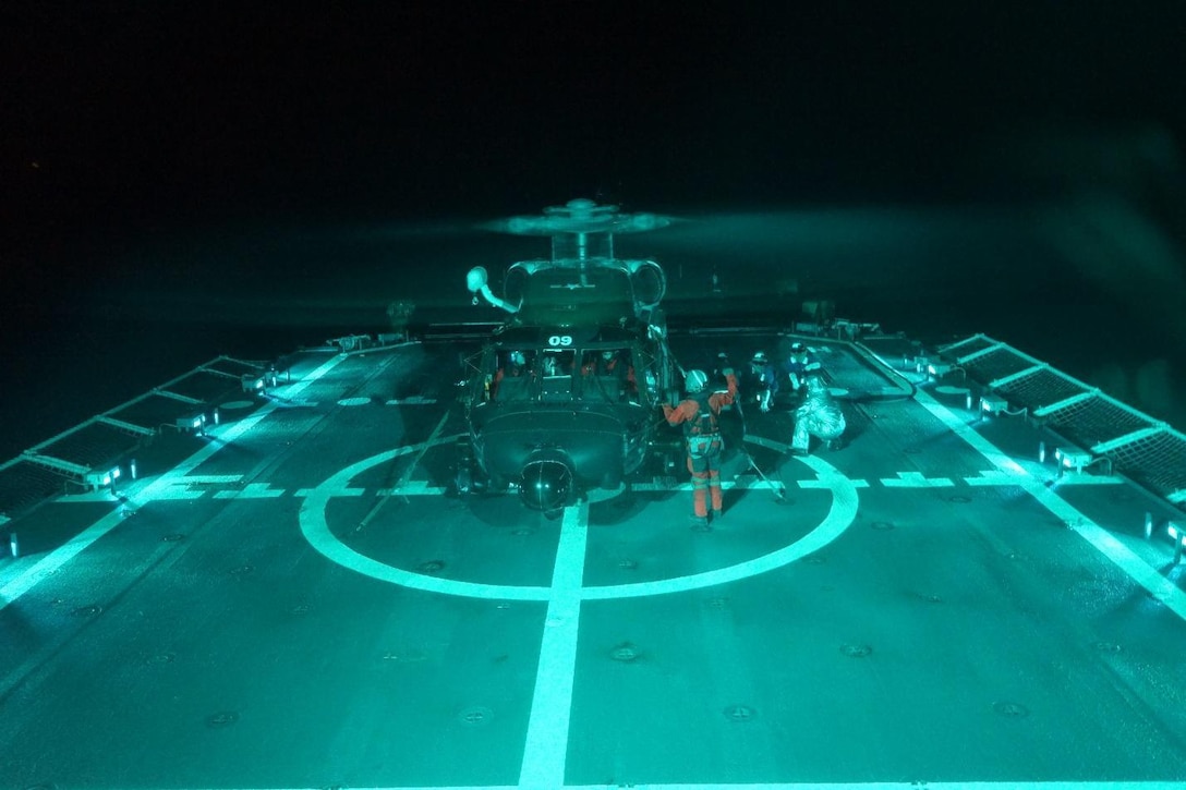 Coast Guard Cutter Hamilton crewmembers refuel an MH-60 Jayhawk helicopter from Air Station Clearwater during a search and rescue case.