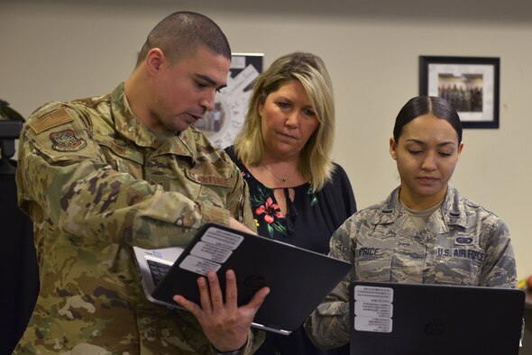 U.S. Air Force Tech. Sgt. Chance Pugh, Christine Seman and 1st Lt. Krystal Price, 335th Training Squadron manpower apprentice course students, discuss content to brief to the class at Keesler Air Force Base, Mississippi, Jan. 23, 2019. Students practice briefing often as it is a main requirement of the career field. (U.S. Air Force photo by Airman 1st Class Kimberly L. Mueller)