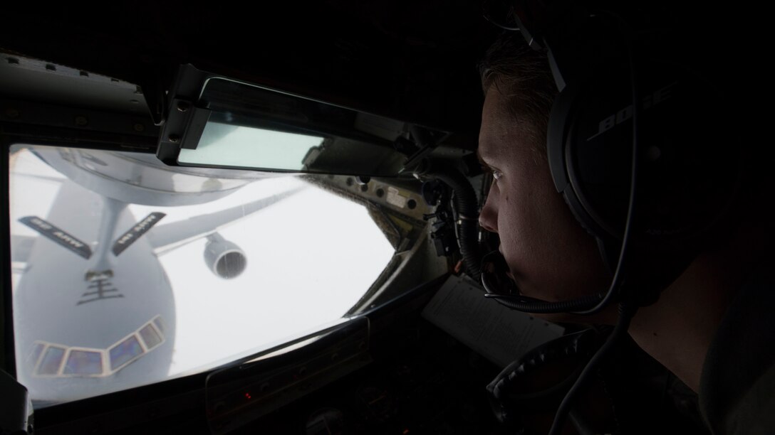 Airman 1st Class Tristen Lang, 384th Air Refueling Squadron in-flight refueling specialist, performs an in-flight refueling connection with a KC-46 Pegasus over Washington, January 22, 2019. A KC-135 Stratotanker crew trained on with the crew of the new KC-46 on mid-air refueling procedures of the KC-46, which can both receive and dispense fuel. (U.S. Air Force photo/Airman 1st Class Lawrence Sena)