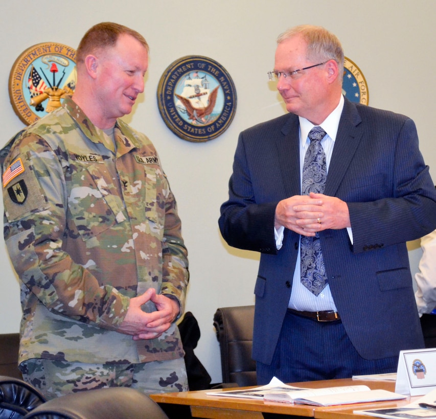Army Col. Matthew Voyles, Medical supply chain director, left, talks with Dr. David Bobb, DHA pharmacy operations division chief, right, at DLA Troop Support in Philadelphia Jan. 24, 2019.