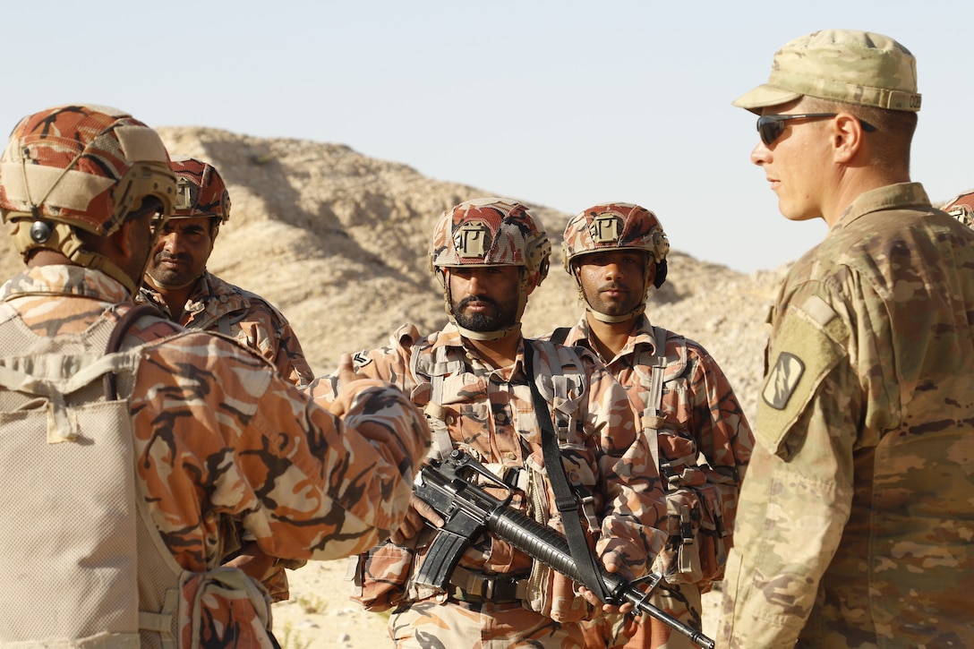 A Soldier from Charlie Company, 2nd Battalion, 198th Armored Regiment, 155th Armored Brigade Combat Team listens as his Omani counterpart discusses movement and maneuver tactics to a squad of Soldiers from the U.S. Army and the Royal Army of Oman in Rabkoot, Oman on Jan. 24, 2019. The two armies are participating in a bilateral exercise called Inferno Creek 19. The exercise was designed to strengthen military relations between the U.S. Army and the Royal Army of Oman. It is an opportunity for both militaries to build tactical proficiency and gain shared understanding of each other’s forces and support long-term regional stability. (U.S. Army National Guard photo by Spc. Linsey Williams)