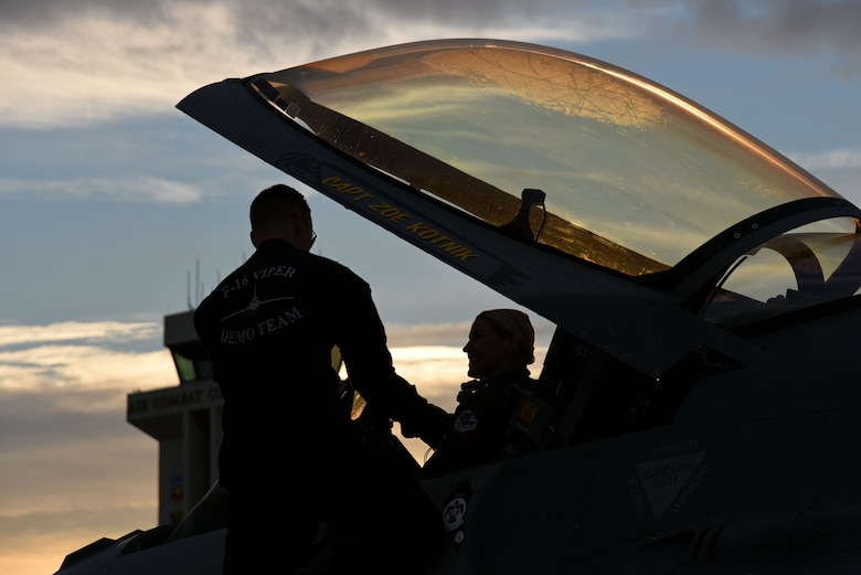 U.S. Air Force Capt. Zoe “SiS” Kotnik, F-16 Viper Demonstration Team (VDT) commander and pilot, sits in her aircraft while shaking the hand of Staff Sgt. Austin Dixon, F-16 VDT dedicated crew chief, prior to performing an aerial demonstration at Joint Base Langley-Eustice, Va., Jan. 29, 2019.