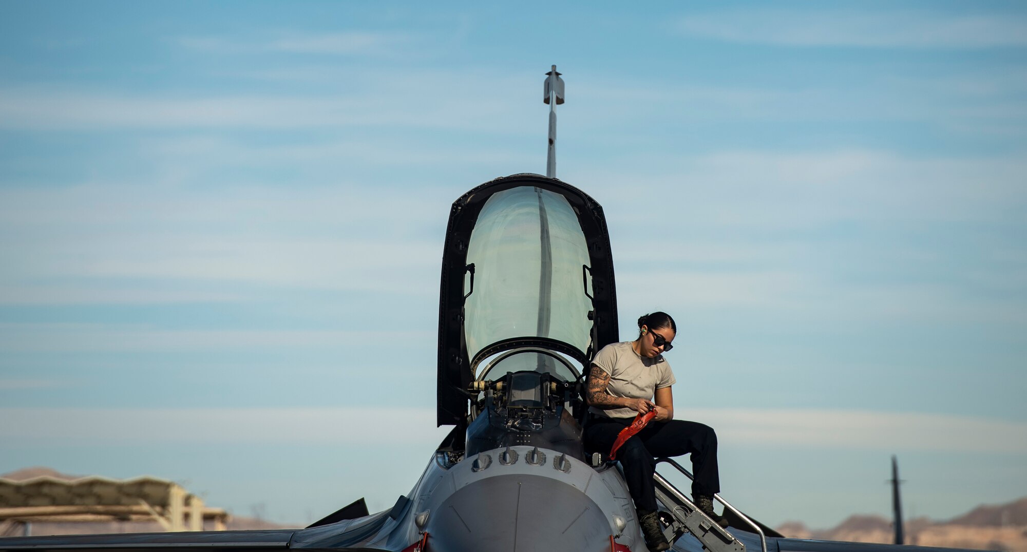 U.S. Air Force Airman 1st Class Alyssa Rodriguez, 20th Aircraft Maintenance Squadron, 79th Aircraft Maintenance Unit crew chief, gathers safety pins from an F-16CM Fighting Falcon during Exercise Red Flag 19-1 at Nellis Air Force Base, Nev., Jan. 28, 2019.