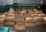 U.S. Navy Fire Controlman (Aegis) 2nd Class Wesley Helm, assigned to the guided-missile destroyer USS Chung-Hoon (DDG 93), watches a shipment of narcotics aboard a dhow that was discovered transporting 4,700 kilograms of hashish in the Gulf of Aden, Jan. 24, 2019. Chung-Hoon is deployed to the U.S. 5th Fleet area of operations in support of naval operations to ensure maritime stability and security. (U.S. Navy photo by Mass Communication Specialist 2nd Class Logan C. Kellums)