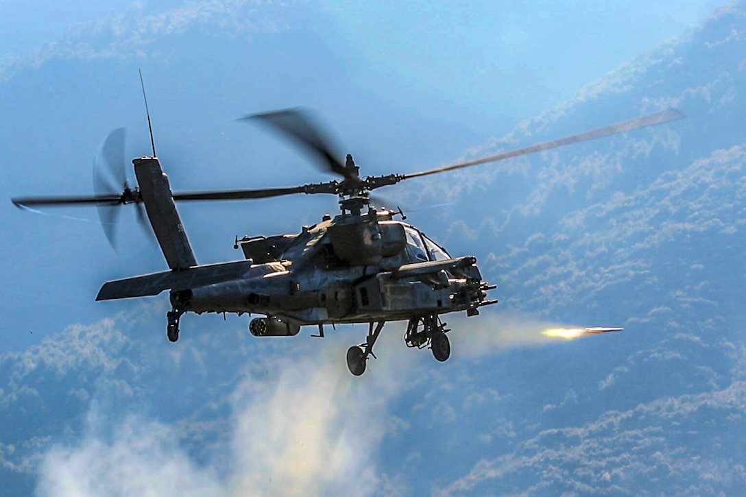 A helicopter fires a rocket.