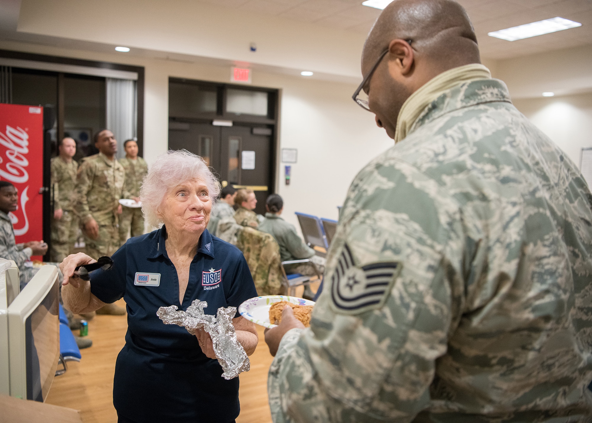Josie Donithan, USO Delaware volunteer, serves fried chicken to honor guard team members and mortuary staff prior to a dignified transfer Jan. 24, 2019, at Dover Air Force Base, Delaware. USO Delaware served approximately 82,000 servicemembers and their families in 2018. (U.S. Air Force photo by Mauricio Campino)