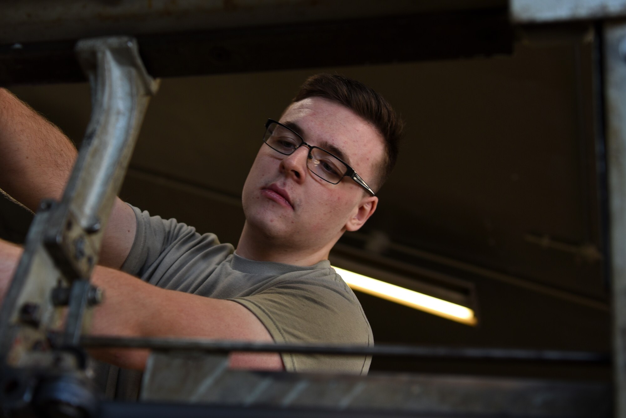 U.S. Air Force Airman 1st Class Peter Lockett, 20th Equipment Maintenance Squadron aircraft metals technology journeyman, prepares to cut a metal pole at Shaw Air Force Base, S.C., Jan 28, 2019.