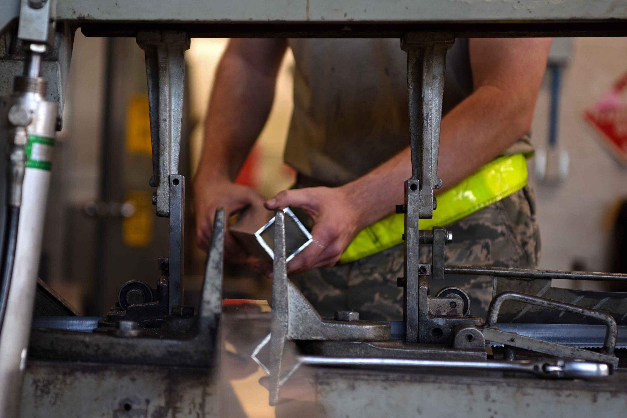 U.S. Air Force Airman 1st Class Peter Lockett, 20th Equipment Maintenance Squadron (EMS) aircraft metals technology journeyman, picks up a newly cut piece of metal at Shaw Air Force Base, S.C., Jan 28, 2019.