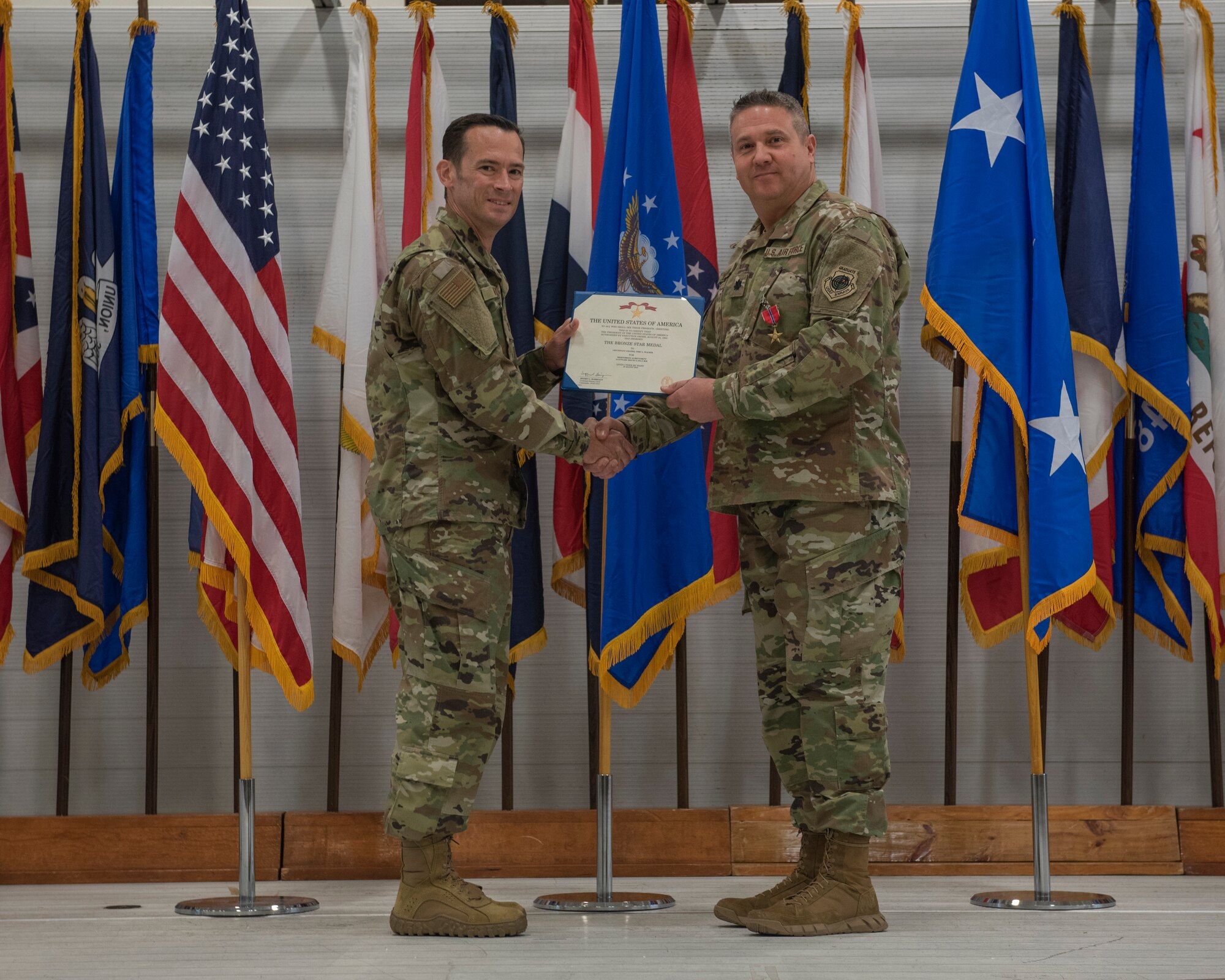 U.S. Air Force Lt. Col. Toby Walker, 33rd Maintenance Group deputy commander, right, is awarded the Bronze Star by Col. Paul Moga, 33rd FW commander, during the 2018 Annual Awards Ceremony Jan. 25, 2019, at Eglin Air Force Base, Fla. While deployed to Iraq, Walker served as the 370th Air Expeditionary Advisory Group deputy commander. During his deployment, Walker led over 200 Airmen from 58 different Air Force specialties across six geographically separated locations in direct support of Operation INHERENT RESOLVE. (U.S. Air Force photo by Staff Sgt. Peter Thompson)