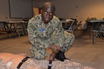 Seaman Gideon Osei practices patient care by working on a mannequin in a training room at the Medical Education and Training Campus at Joint Base San Antonio-Fort Sam Houston. Osei, who emigrated to the U.S. from Ghana three years ago, graduated from the METC Hospital Corpsman Basic Program Jan. 28.