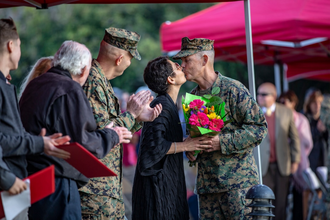 U.S. Marine Corps Col. Jay Hanlon, command inspector general, I Marine Expeditionary Force kisses his wife Heather Pauline Hanlon during his retirement ceremony at the Ranch House, Camp Pendleton, Calif., Jan 11, 2018.