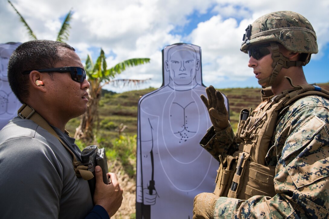 U.S. Marine Corps Lance Cpl. Jacob Coleman, a military policeman with Law Enforcement Detachment, Task Force Koa Moana, talks to an officer with Palau Police Force, during  a live-five training at Ngardmau, Republic of Palau, Nov. 28.