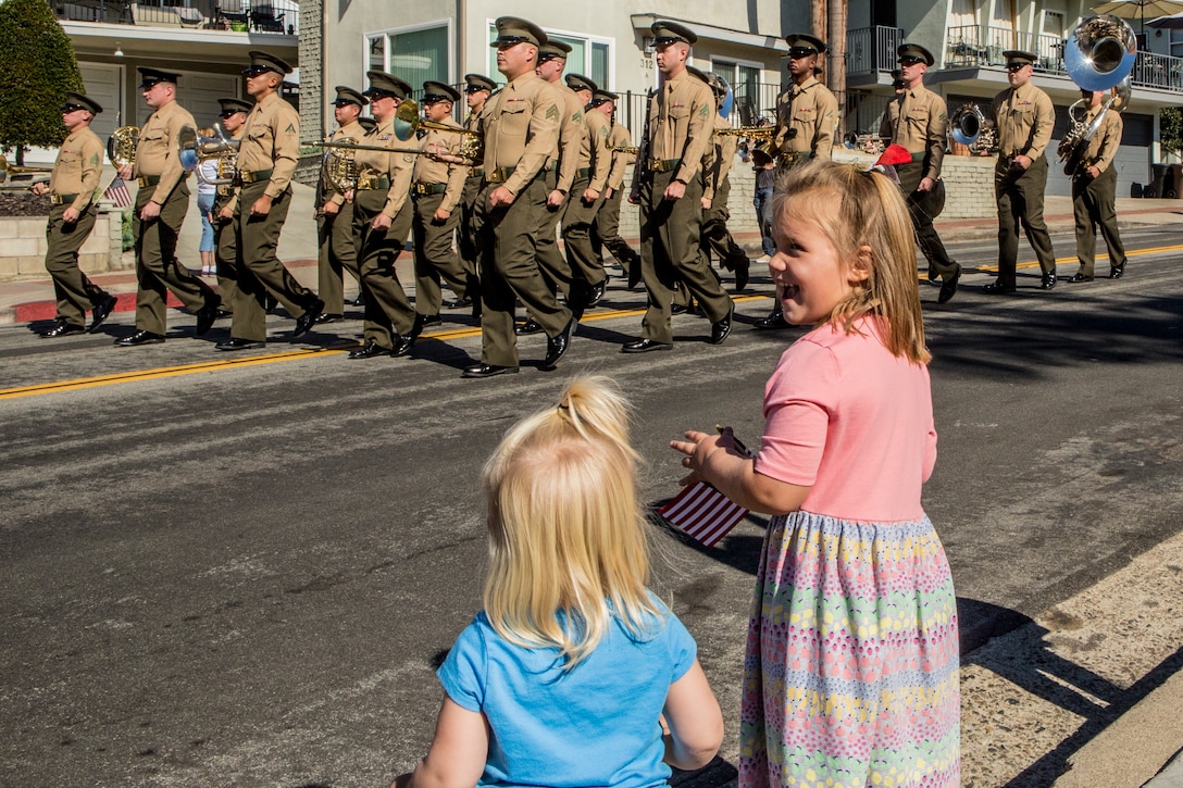 Children cheer as the 1st Marine Division Band’s Brass Quintet marches by during the San Clemente Veteran’s Day Parade in San Clemente, Calif., Nov. 9, 2018. Local families, community members, and veterans gathered to attend the parade to celebrate the homecoming of 2nd Battalion, 4th Marine Regiment, 1st Marine Division, I Marine Expeditionary Force, from their recent deployment to Australia as part of Marine Rotational Force-Darwin. A homecoming ceremony and a Veteran's Day commemoration followed the parade to recognize the 243rd Marine Corps Birthday and to celebrate and honor all veterans. (U.S. Marine Corps photo by Cpl. Bradley J. Morrow)